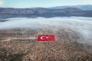 Mersin'de 22 dönümlük araziye işlenen Türk bayrağı siste görüntülendi